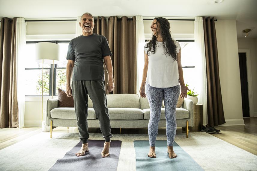 Couple doing yoga at home
