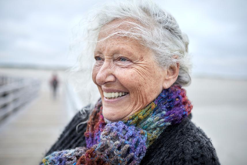 senior woman smiling on a boardwalk