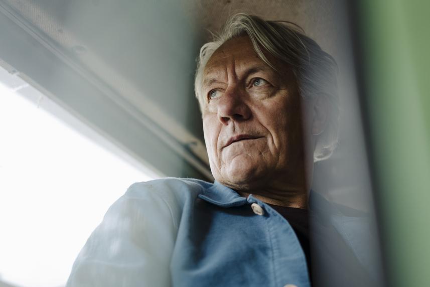 Man looking out window